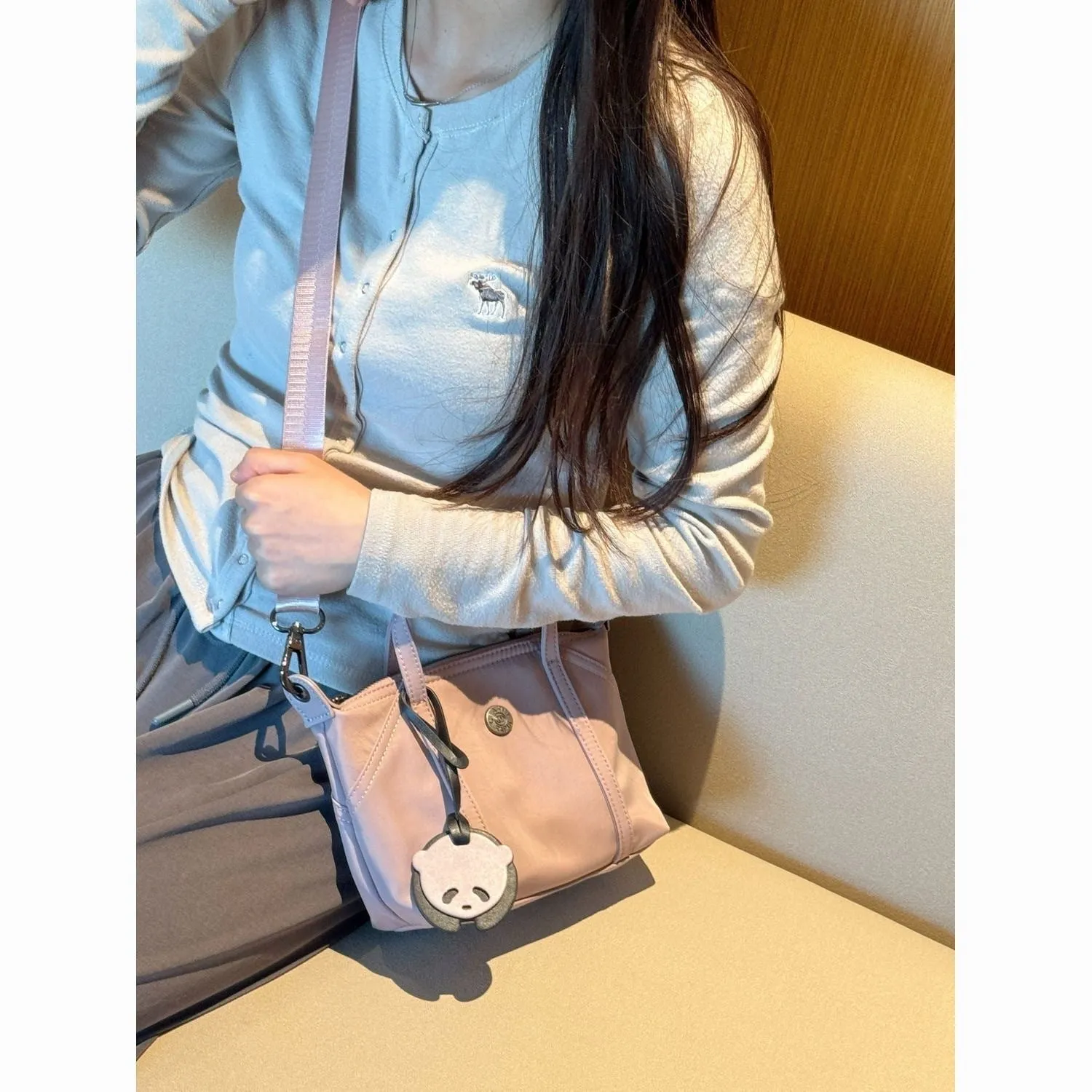 Casual lightweight nylon crossbody bag in dumpling shape, available colours black brown orange pink yellow, with pendant