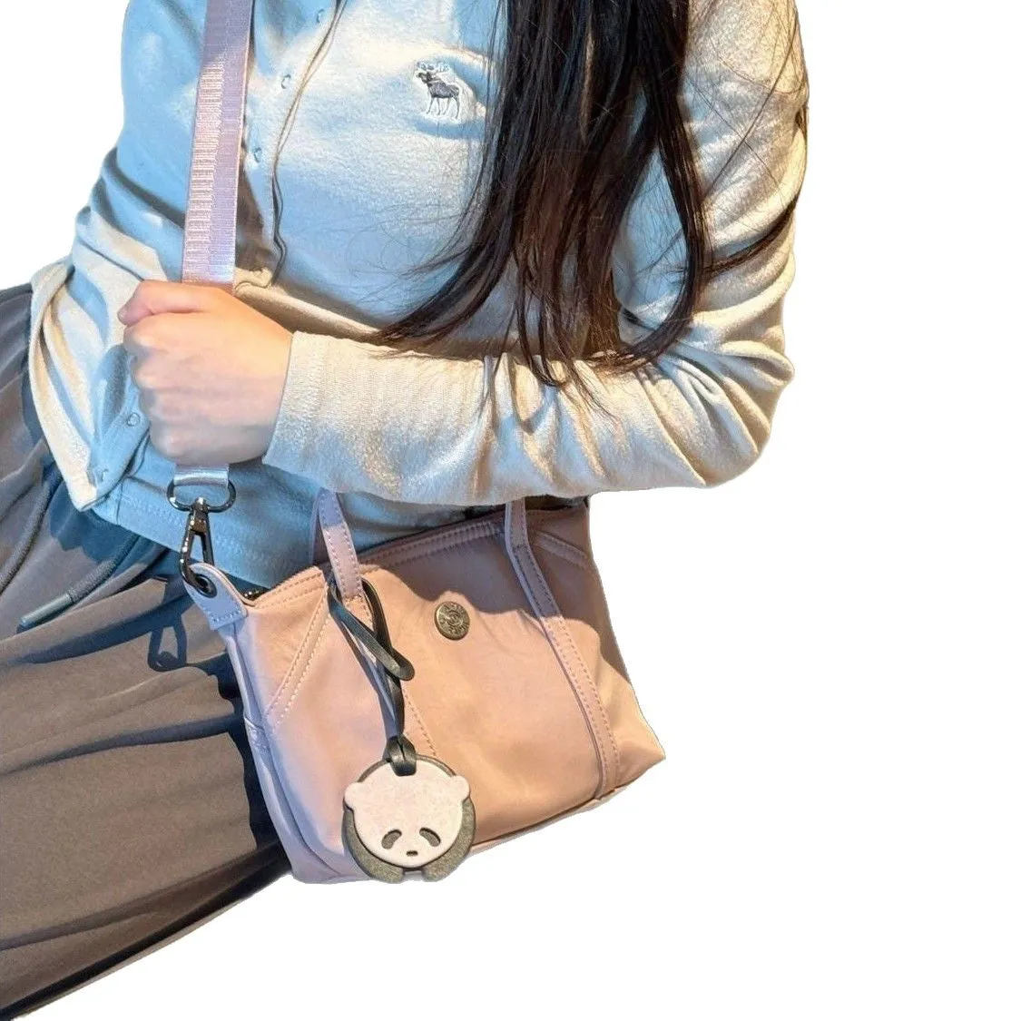 Casual lightweight nylon crossbody bag in dumpling shape, available colours black brown orange pink yellow, with pendant