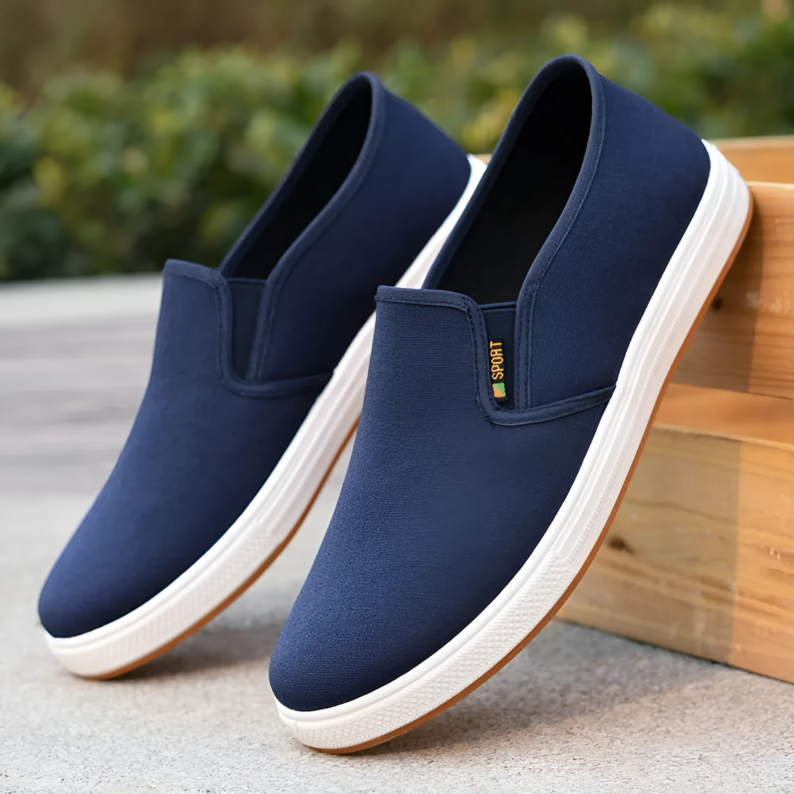 Men's low-top black canvas slip-on shoes with round toe and shallow mouth on a composite sole.