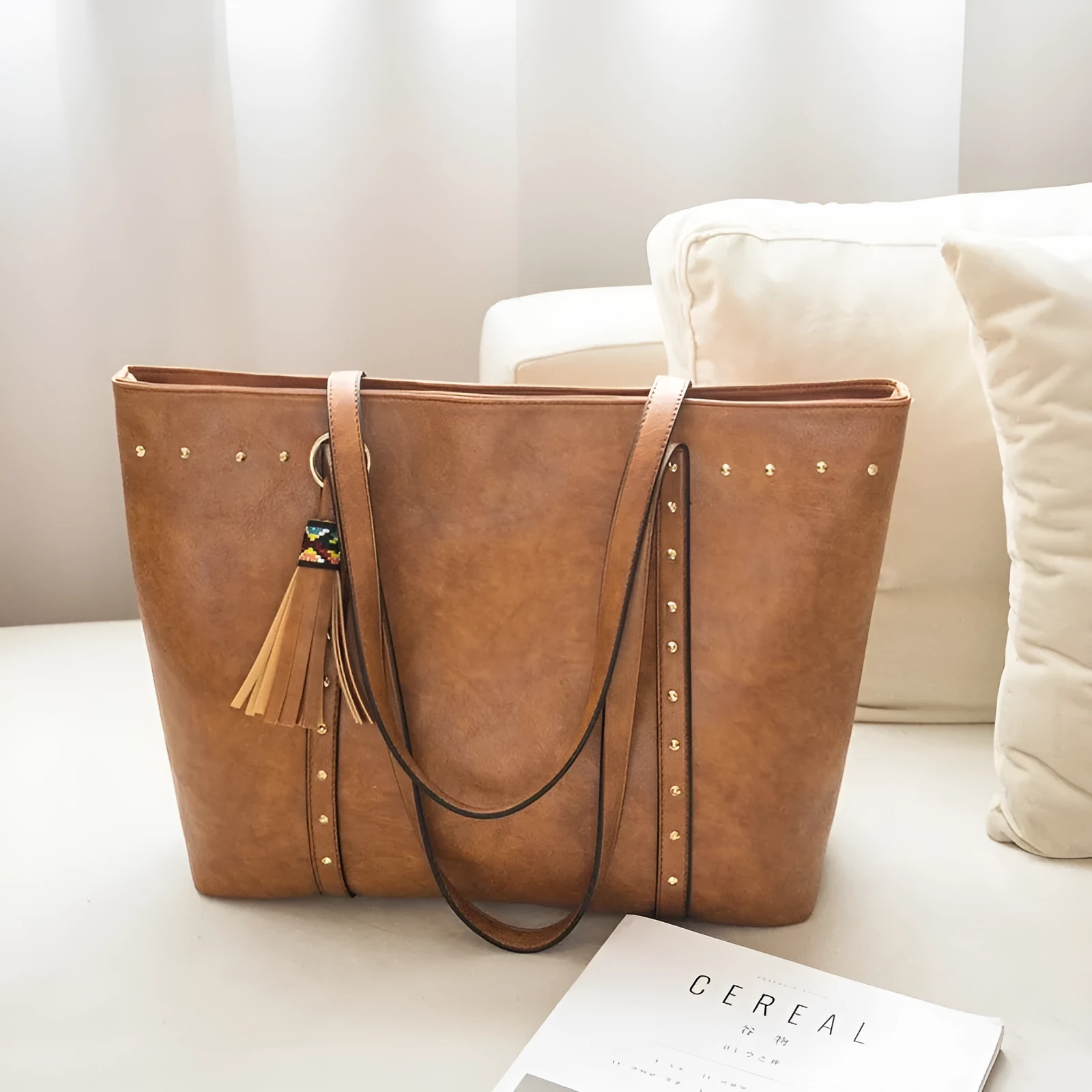 Women's shoulder crossbody tote bag in black with crossbody strap and open top