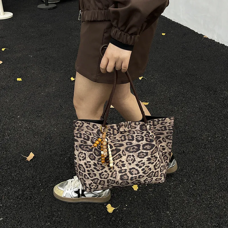 Leopard print polyester hand-held tote bag with double shoulder straps on a white background