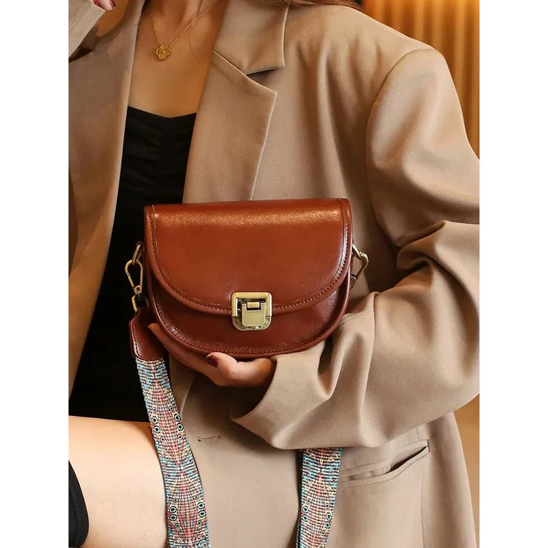Vegetable tanned top layer cowhide half moon shoulder bag with lock detail, black colour, sandwich pocket, double straps