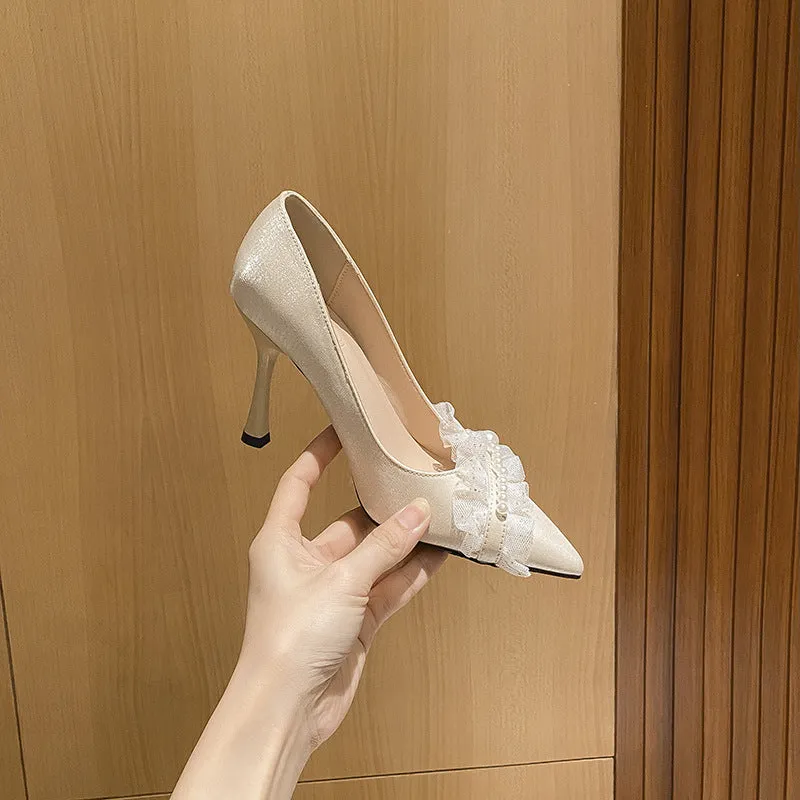 Women's stiletto heels in champagne colour with satin upper, pointed toe, and decorative lace and beading