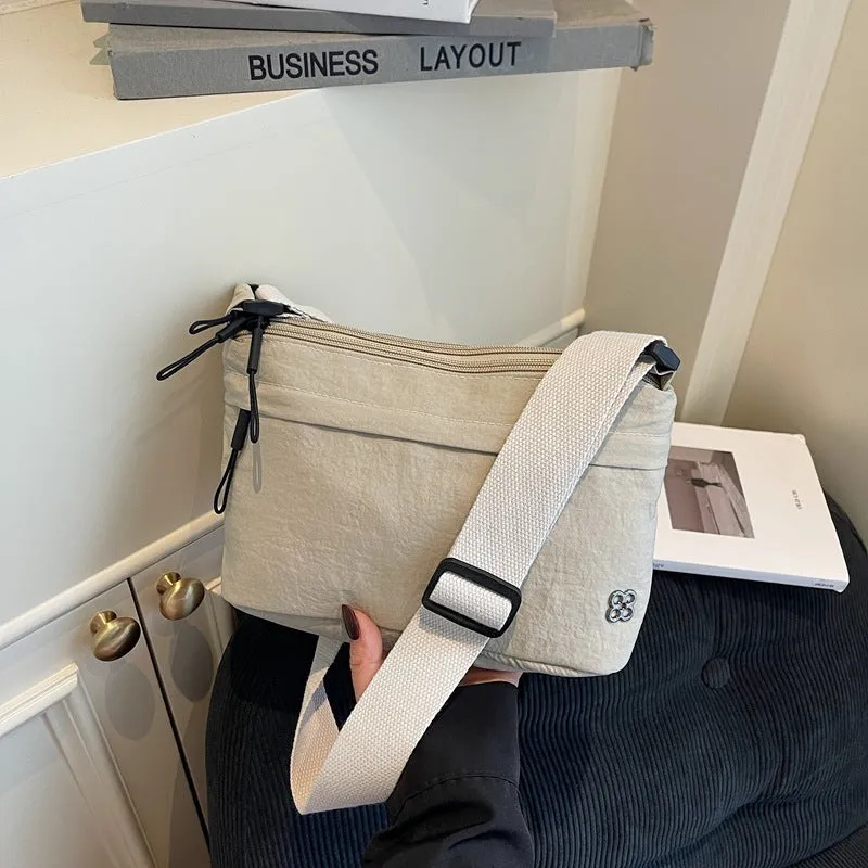 Soft cloth daily lightweight commuter crossbody bag in beige with sandwich pocket and sewn-thread detailing
