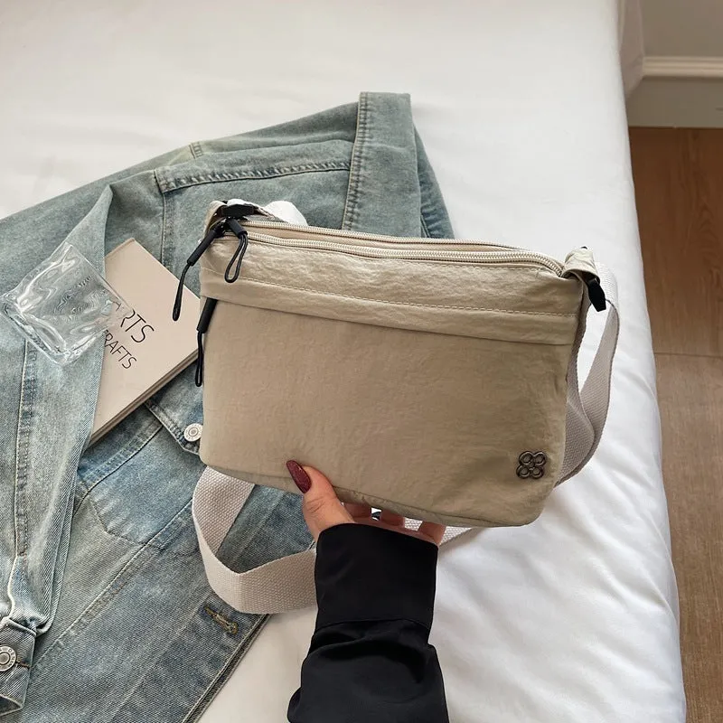 Soft cloth daily lightweight commuter crossbody bag in beige with sandwich pocket and sewn-thread detailing