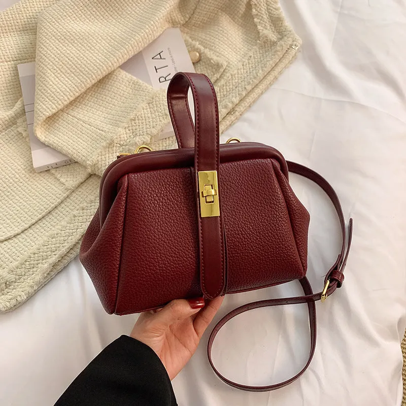 PU leather shoulder bag in cross-square shape with visible sewing line detail, available in four colours