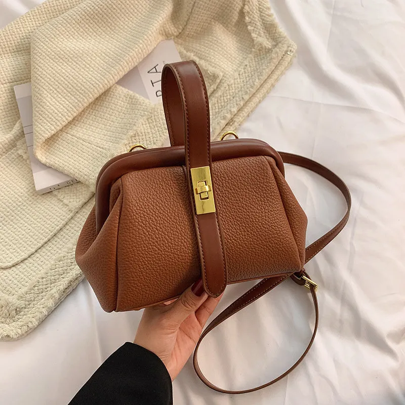 PU leather shoulder bag in cross-square shape with visible sewing line detail, available in four colours