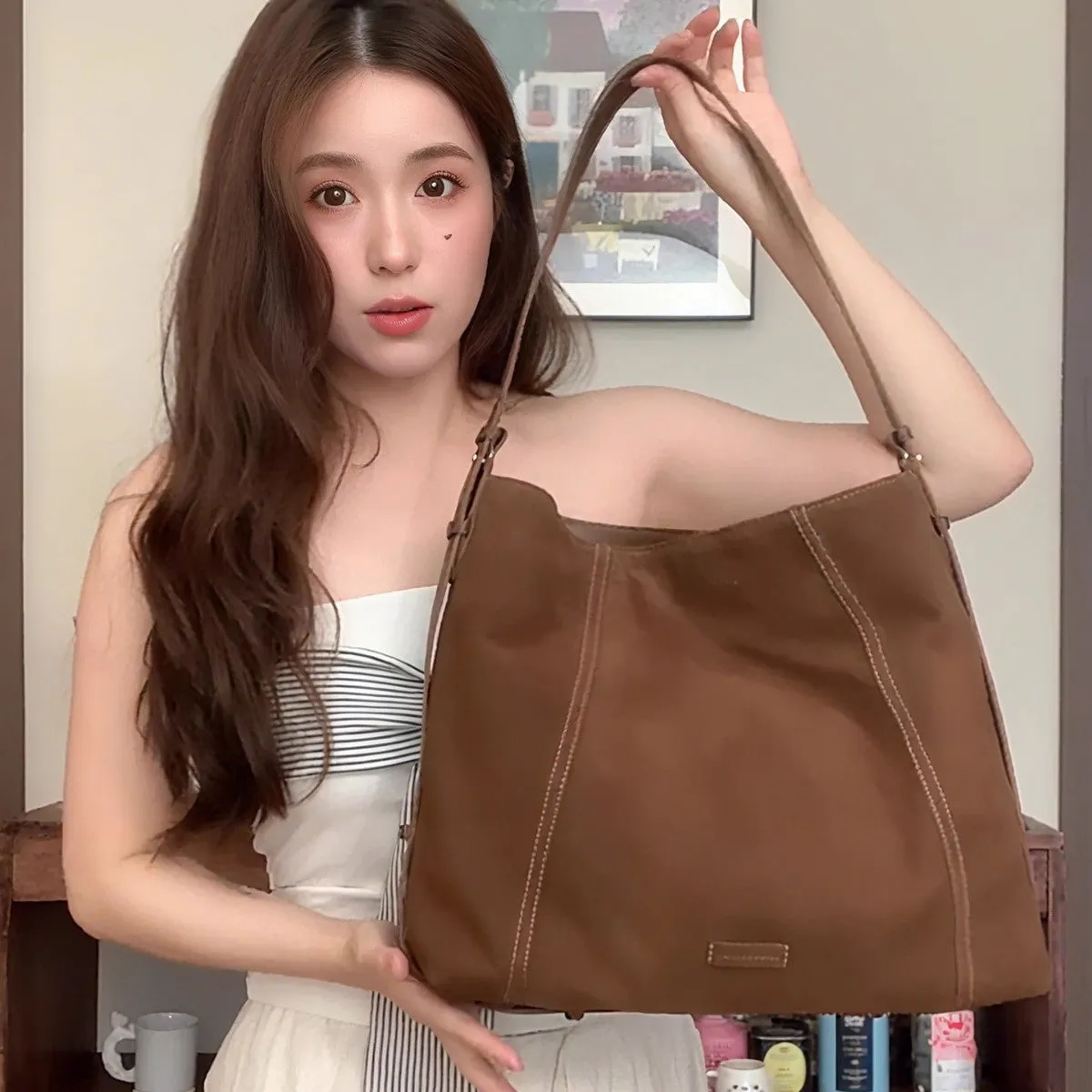 Large capacity soft suede messenger bag in coffee colour with single shoulder strap and sewing line detail