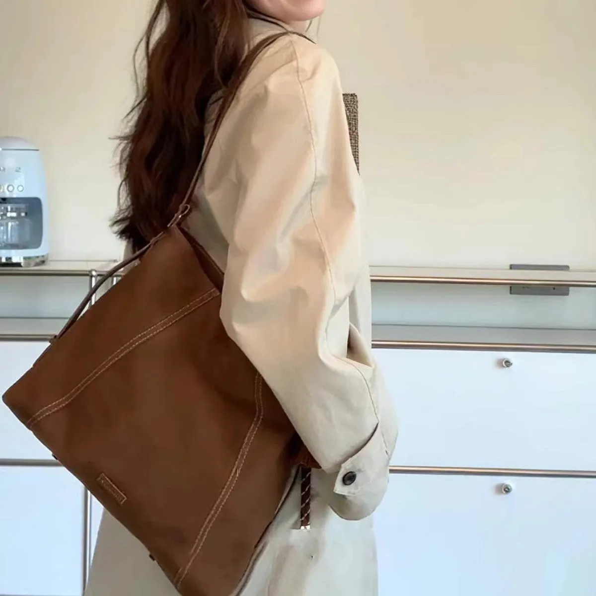 Large capacity soft suede messenger bag in coffee colour with single shoulder strap and sewing line detail