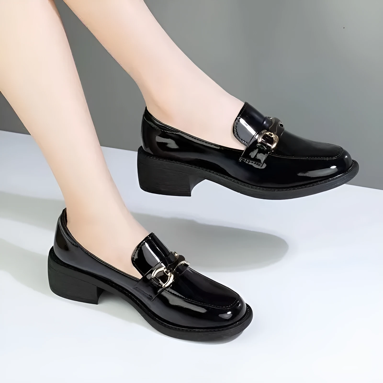 Dark green glossy chunky heel loafers for women with metal buckle and round toe on a white background