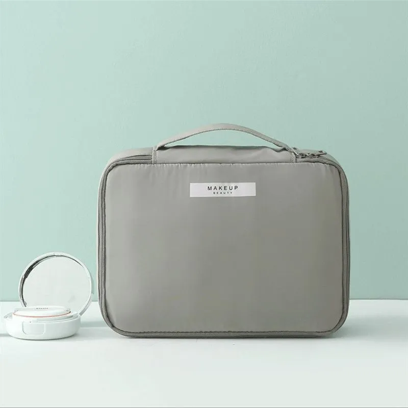 Nylon cube cosmetic bag in blue with sealed closure, available in large and small sizes for travel makeup storage