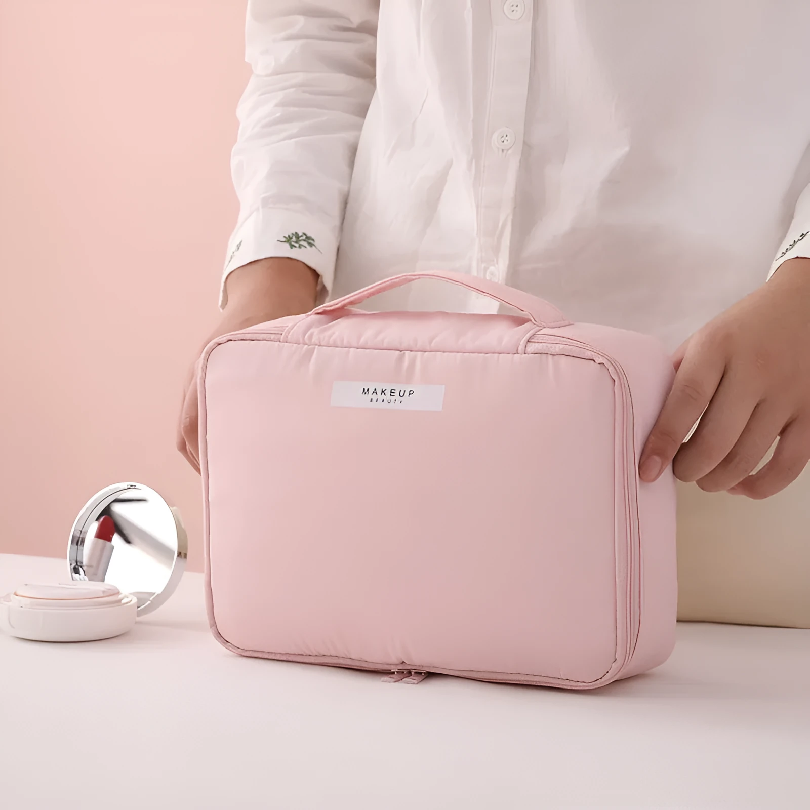 Nylon cube cosmetic bag in blue with sealed closure, available in large and small sizes for travel makeup storage