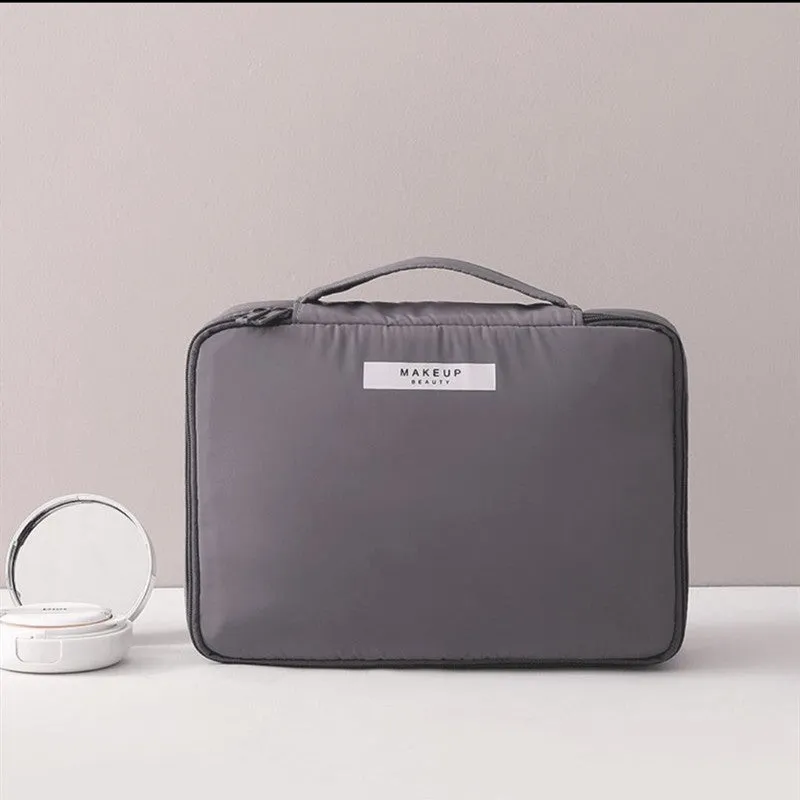 Nylon cube cosmetic bag in blue with sealed closure, available in large and small sizes for travel makeup storage