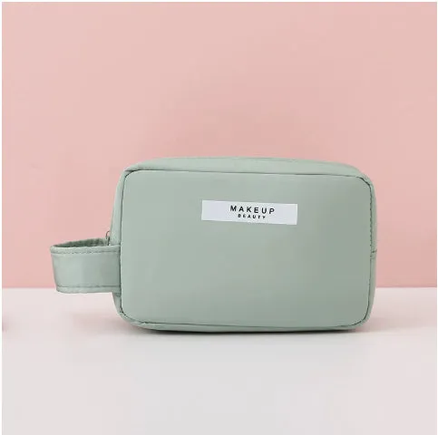 Nylon cube cosmetic bag in blue with sealed closure, available in large and small sizes for travel makeup storage