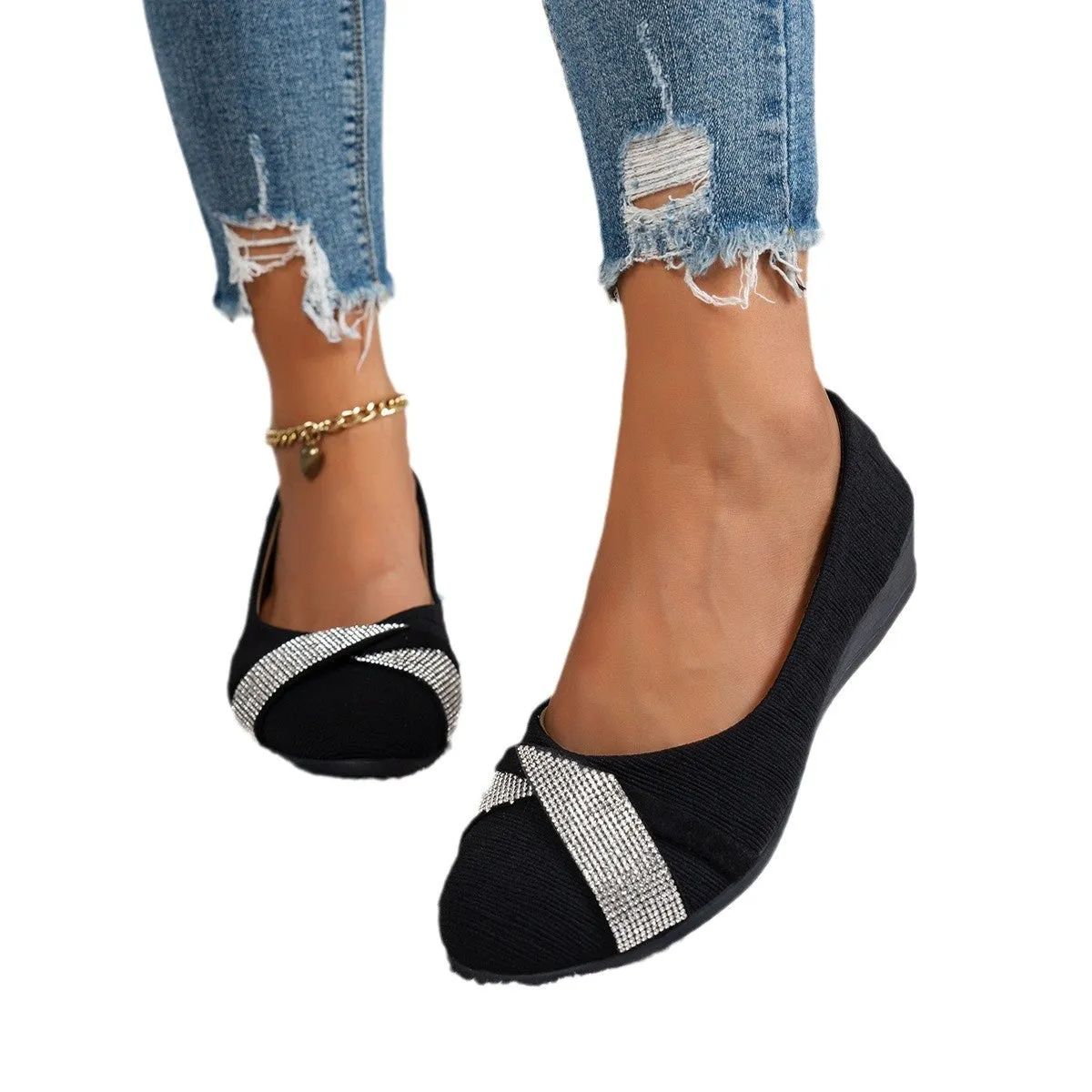 Women's black casual slip-on shoes with rhinestone details and a chunky heel on a white background.