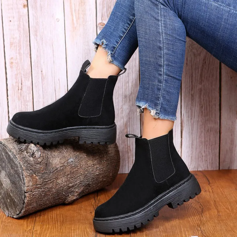 Women's Martin boots in solid colour with chunky platform sole, flat heel, and leather stitching