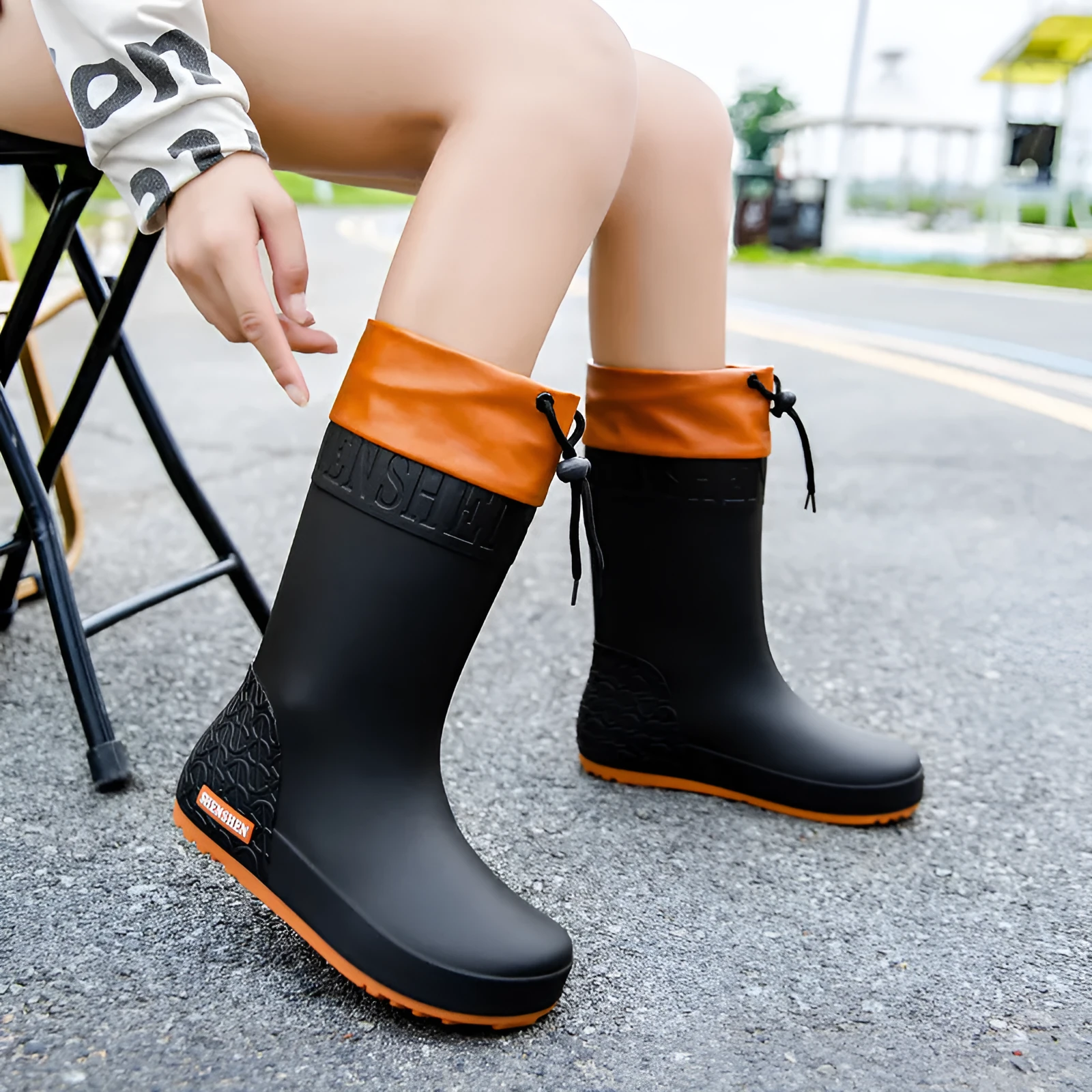 Women's solid colour rain boots with non-slip soles in apricot, black, brown, and pink waterproof finishes