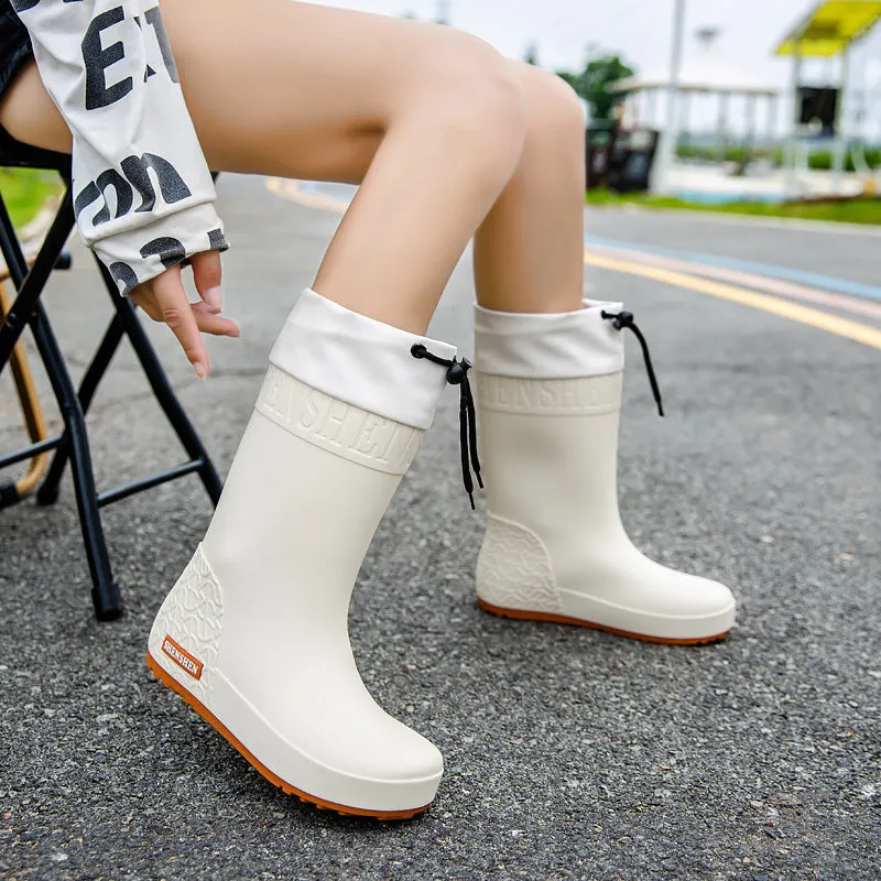 Women's solid colour rain boots with non-slip soles in apricot, black, brown, and pink waterproof finishes