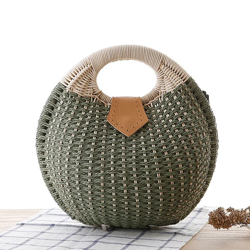 Women's round woven paper rope handbag in beige with hard shell, cover closure, and hard handle