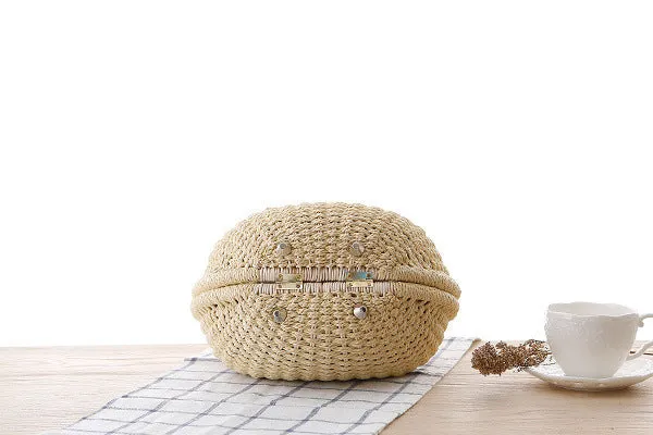 Women's round woven paper rope handbag in beige with hard shell, cover closure, and hard handle