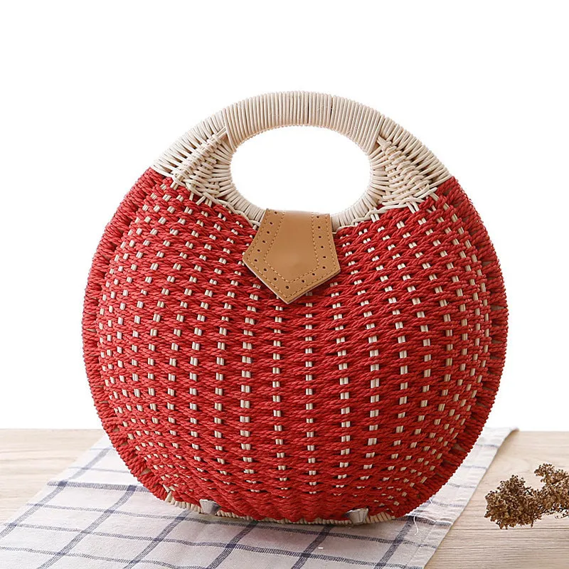 Women's round woven paper rope handbag in beige with hard shell, cover closure, and hard handle