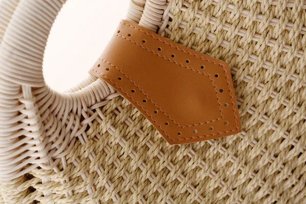 Women's round woven paper rope handbag in beige with hard shell, cover closure, and hard handle