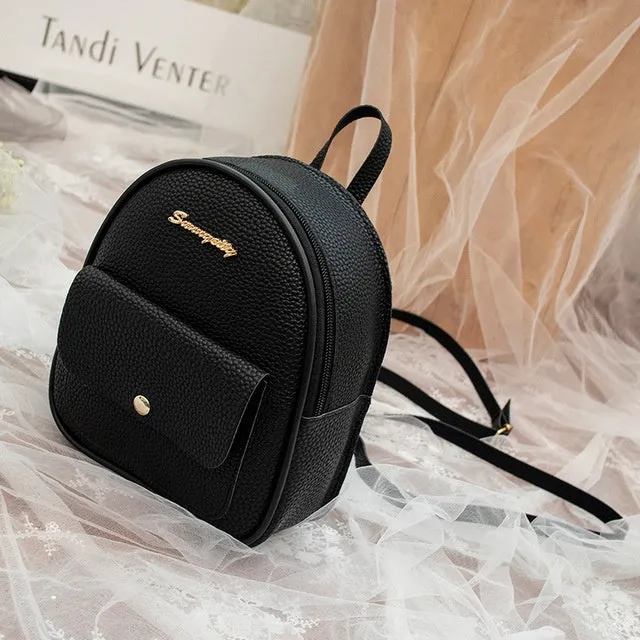 Compact black PU leather women's small backpack with a slim profile and zipper closure.