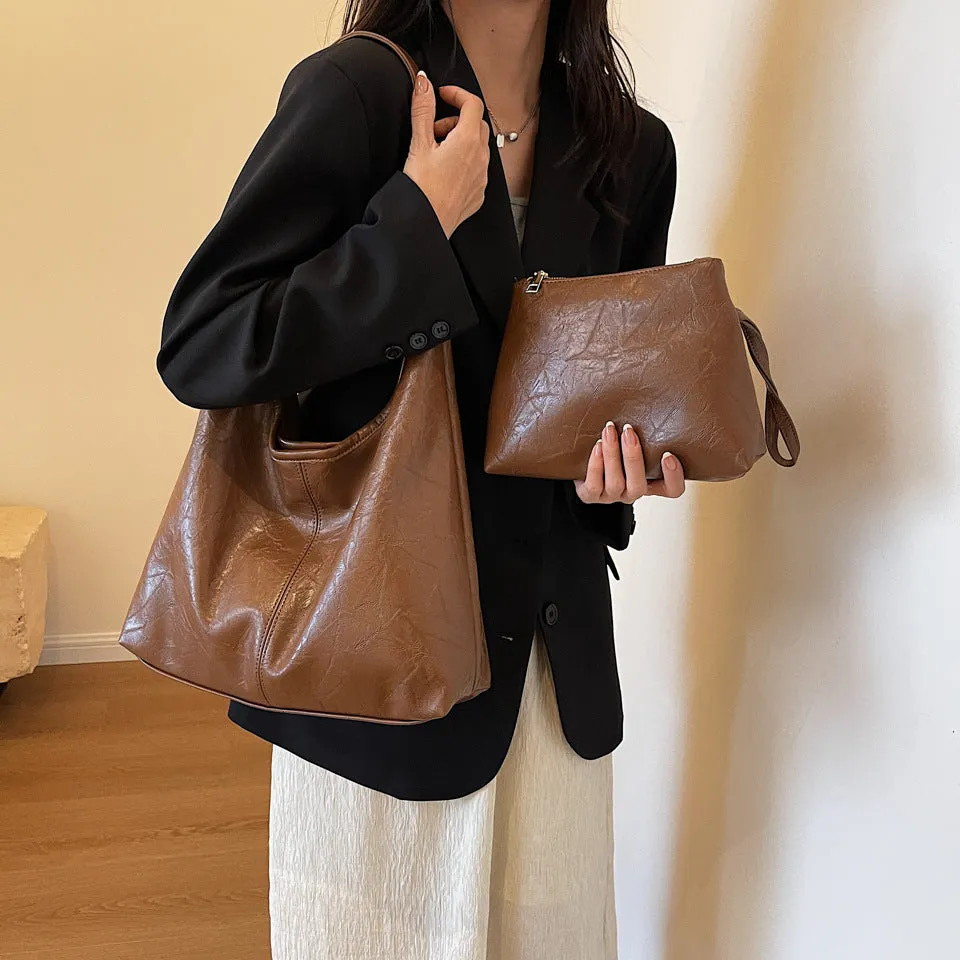Women's large capacity PU shoulder tote bag in brown with sewing line detail and single strap