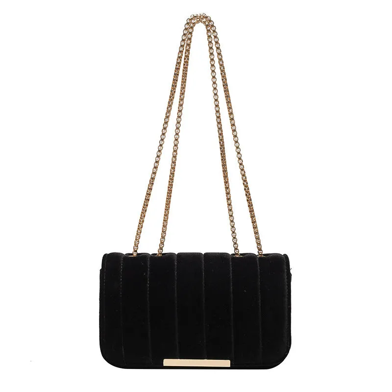 One shoulder velvet chain crossbody bag in solid colour, small square shape with gold chain strap, on white background.