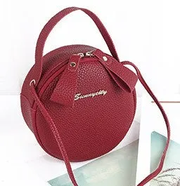 Women's round PU leather crossbody bag in circular shape, 17cm wide, with separate pouch