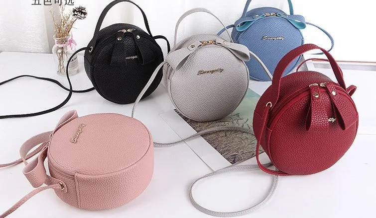 Women's round PU leather crossbody bag in circular shape, 17cm wide, with separate pouch