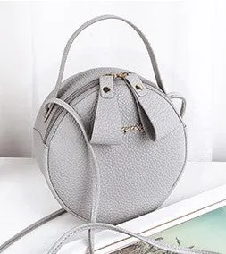 Women's round PU leather crossbody bag in circular shape, 17cm wide, with separate pouch