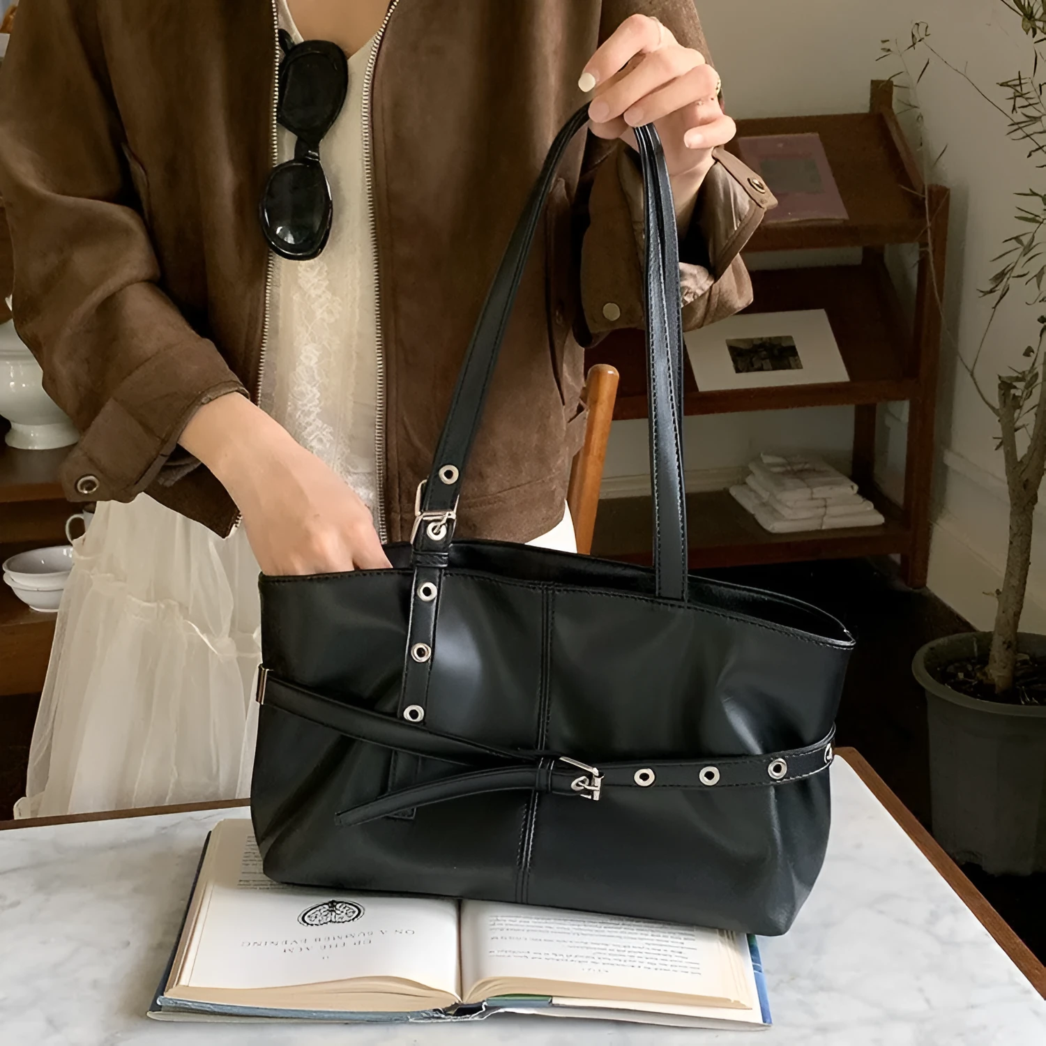 Women's large capacity PU shoulder bag in black with visible sewing line detail and horizontal square shape
