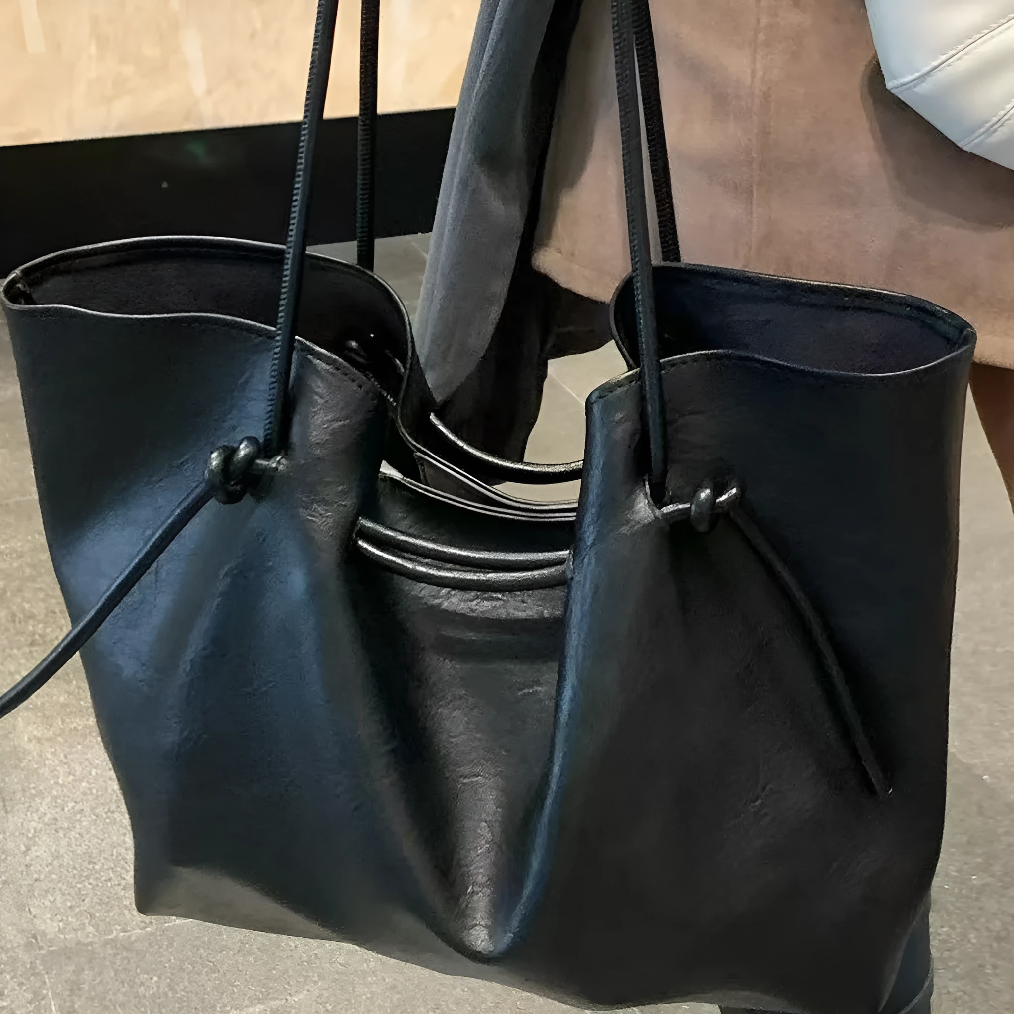 Black PU leather commuter bag with double shoulder straps and solid colour finish, front view