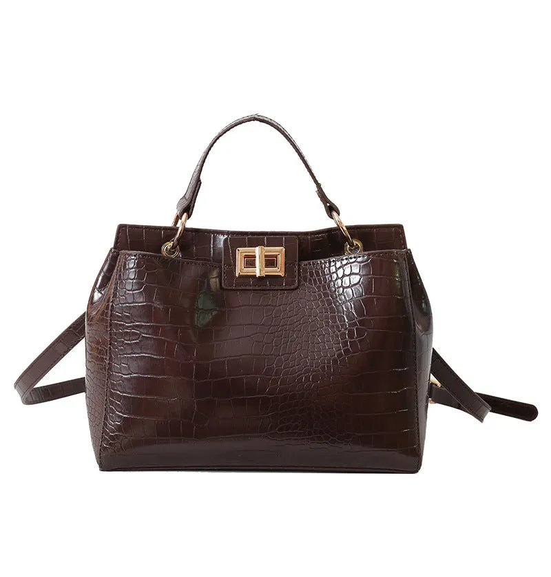Retro western style messenger bag in black stone pattern with shoulder strap and square vertical shape