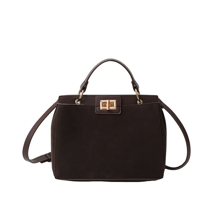 Retro western style messenger bag in black stone pattern with shoulder strap and square vertical shape