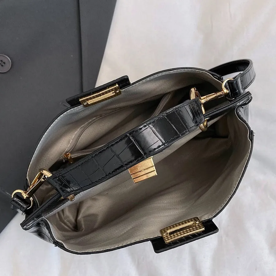 Retro western style messenger bag in black stone pattern with shoulder strap and square vertical shape