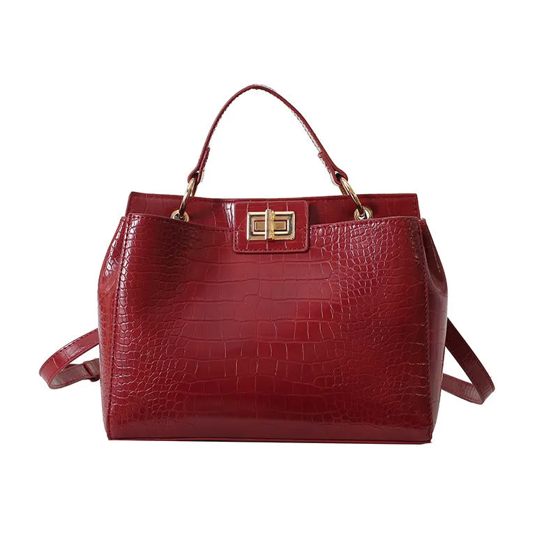 Retro western style messenger bag in black stone pattern with shoulder strap and square vertical shape