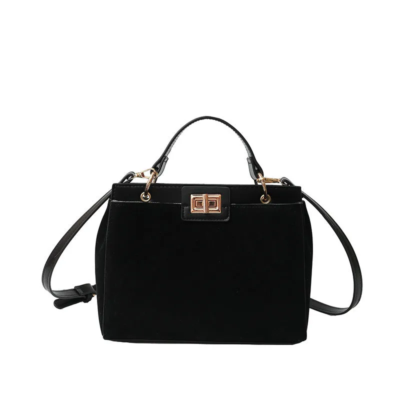 Retro western style messenger bag in black stone pattern with shoulder strap and square vertical shape