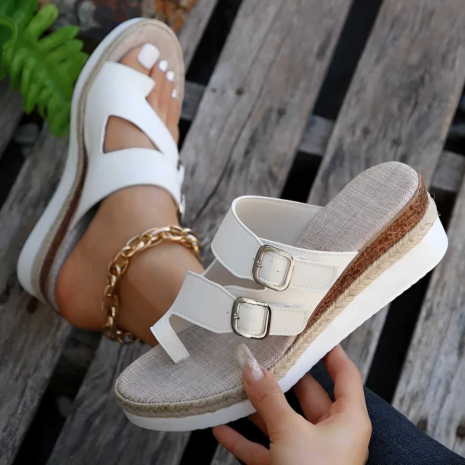 White women's wedge sandals with a woven patent leather upper and peep toe design.