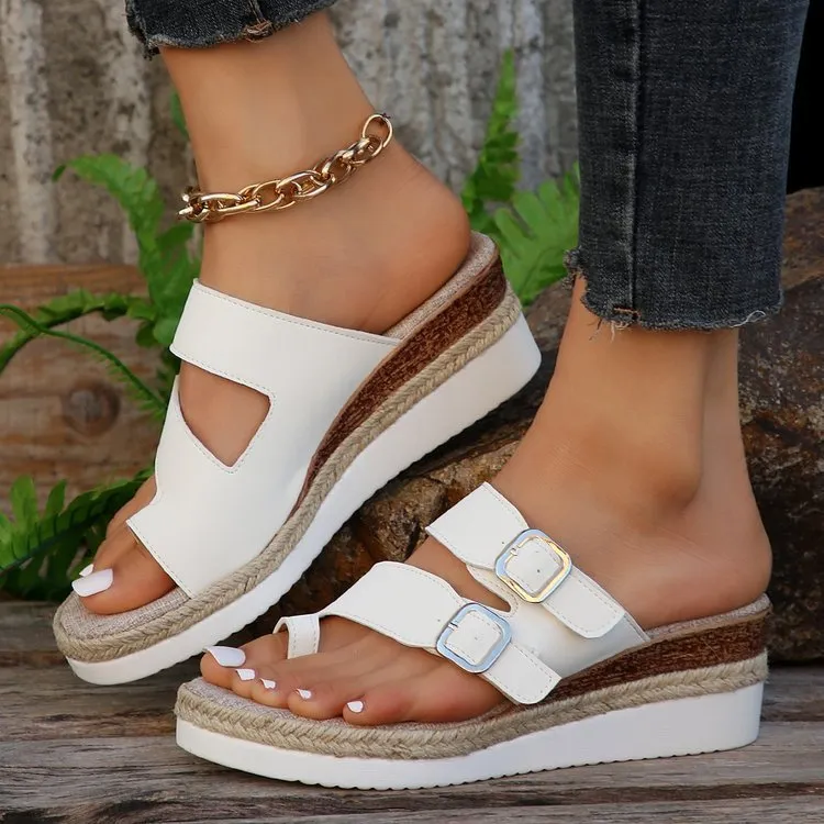 White women's wedge sandals with a woven patent leather upper and peep toe design.