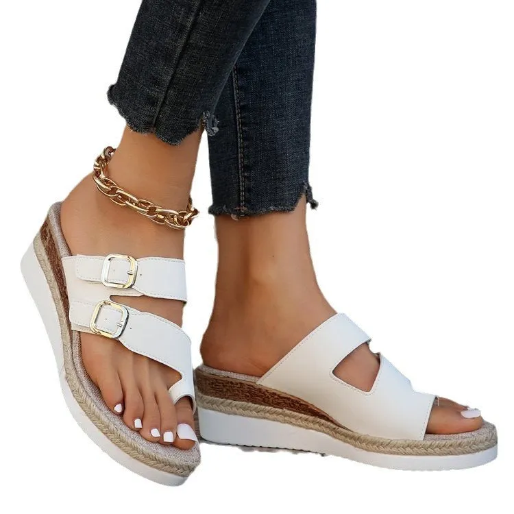 White women's wedge sandals with a woven patent leather upper and peep toe design.