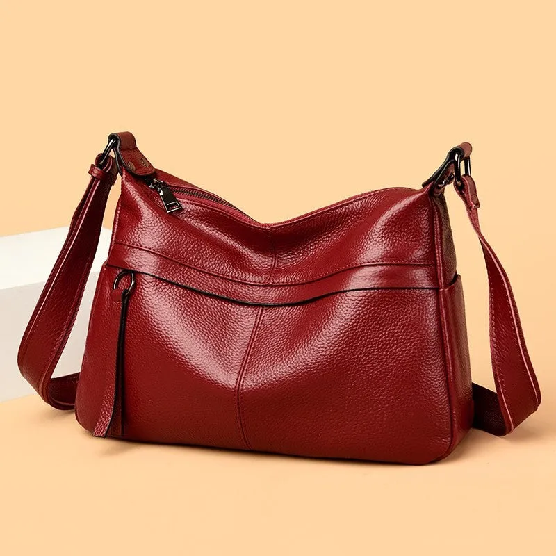 First layer leather one-shoulder crossbody handbag in caramel colour with outer pocket and silver hardware