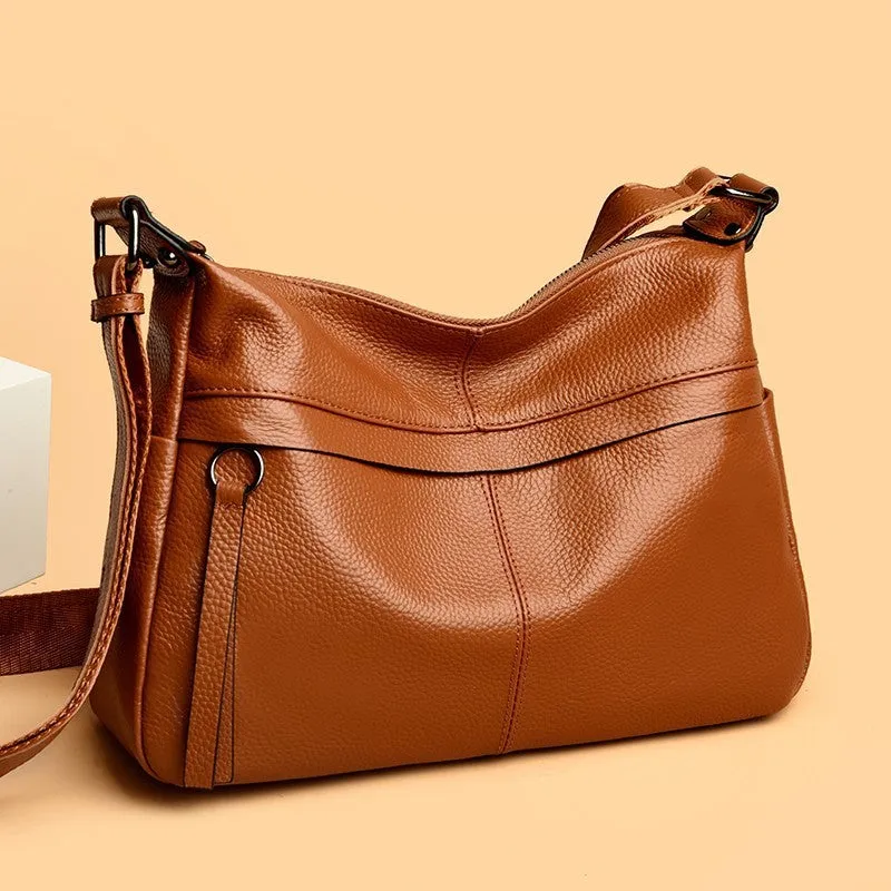 First layer leather one-shoulder crossbody handbag in caramel colour with outer pocket and silver hardware