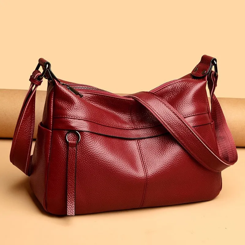 First layer leather one-shoulder crossbody handbag in caramel colour with outer pocket and silver hardware