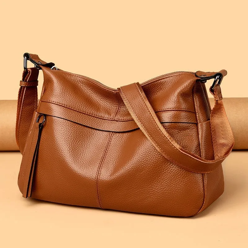 First layer leather one-shoulder crossbody handbag in caramel colour with outer pocket and silver hardware