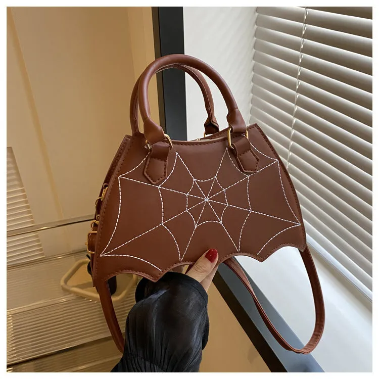 Women's small square PU saddle bag with spider web pattern, crossbody strap, and top handle, available in six colours including black and red