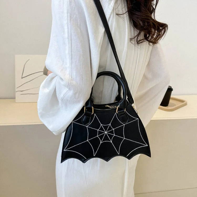 Women's small square PU saddle bag with spider web pattern, crossbody strap, and top handle, available in six colours including black and red