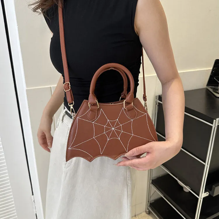 Women's small square PU saddle bag with spider web pattern, crossbody strap, and top handle, available in six colours including black and red