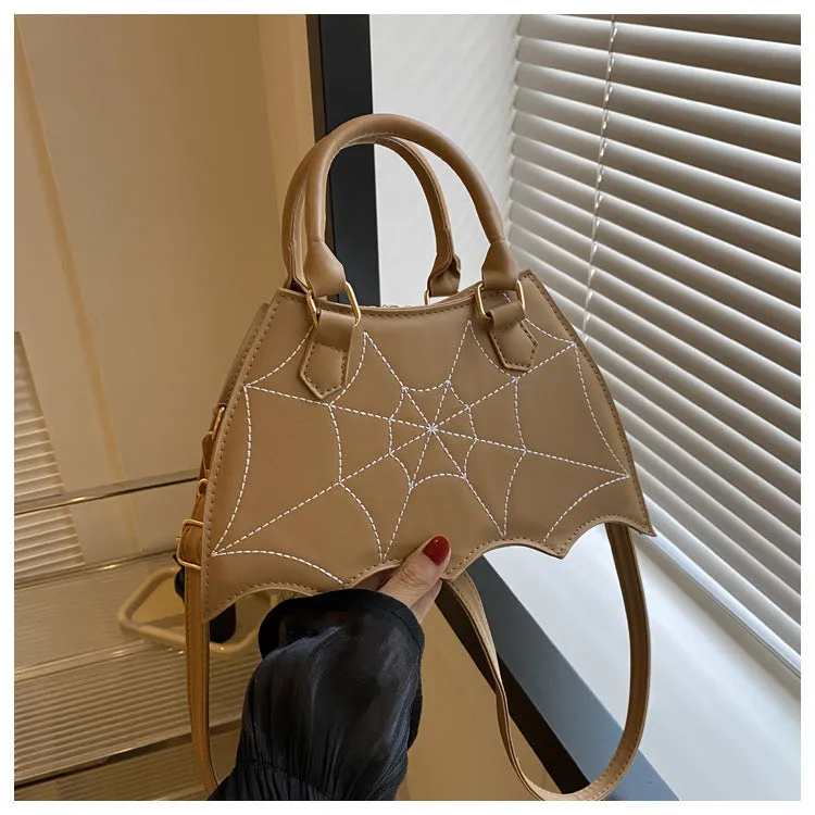 Women's small square PU saddle bag with spider web pattern, crossbody strap, and top handle, available in six colours including black and red